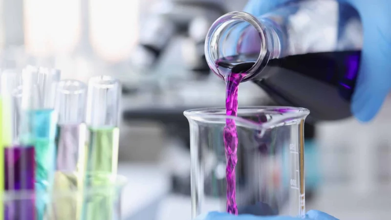 scientist-pouring-pink-chemicals